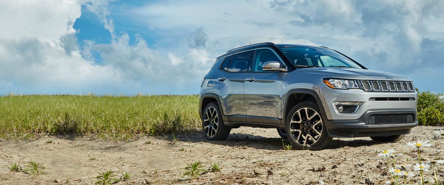 The 2020 Jeep Compass parked on grassy scrubland.