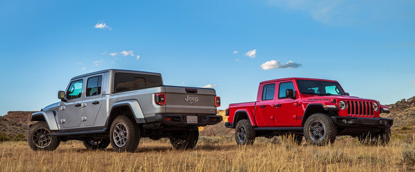 Gladiator Overland and Rubicon trim posing in a grass field