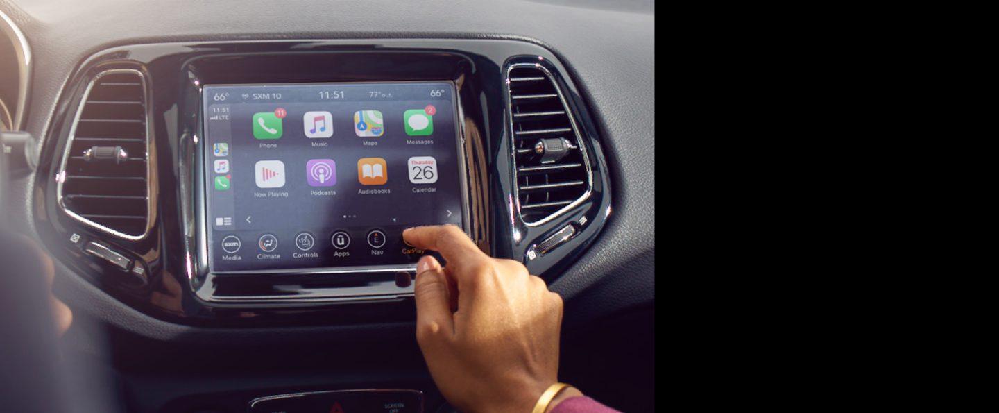A close-up of the Uconnect touchscreen on the 2021 Jeep Compass, displaying the Apple CarPlay selections.