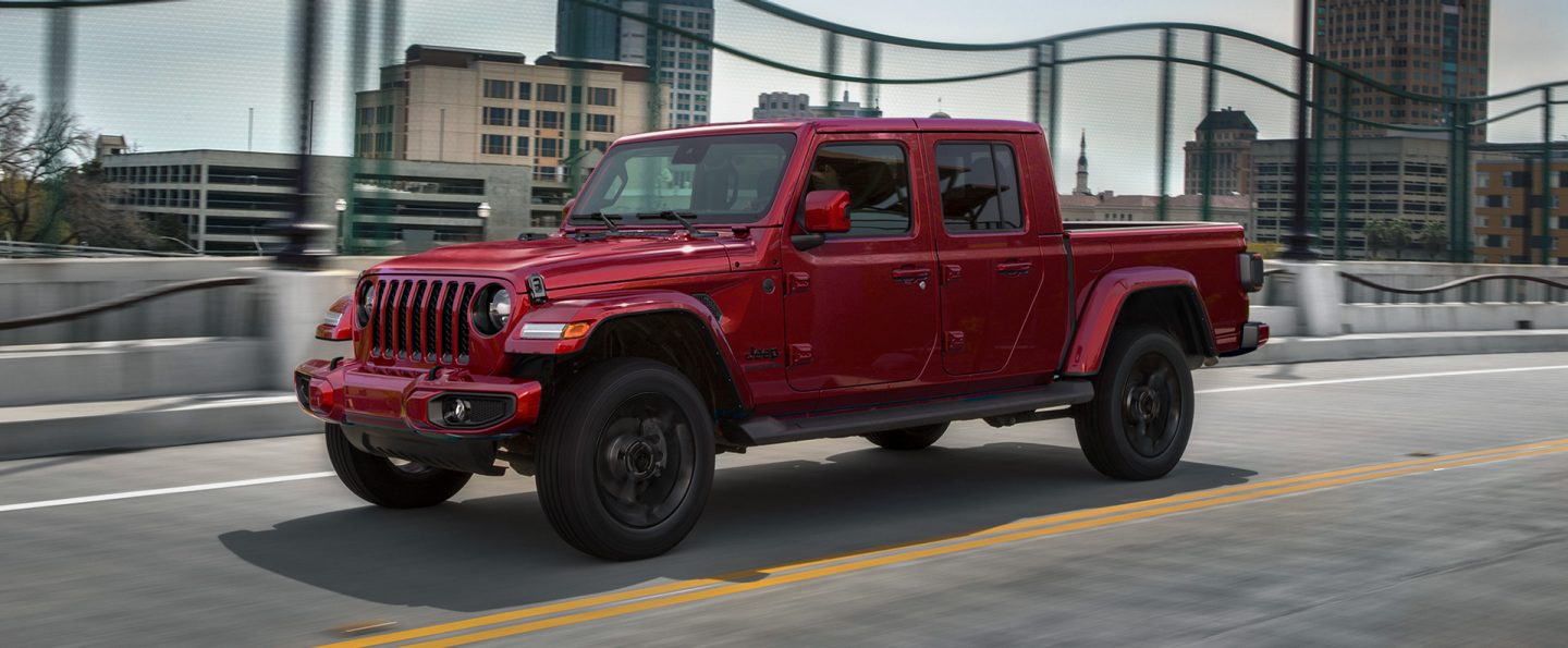 The 2021 Jeep Gladiator Overland being driven on an overpass through a city.
