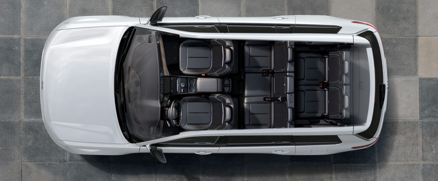 A bird's eye view of a 2021 Jeep Grand Cherokee L with the roof removed, displaying the seven-passenger seating in dark gray.